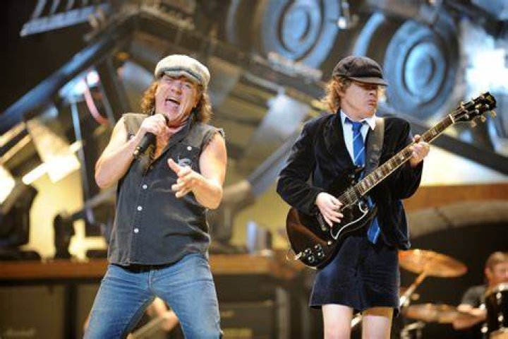 AC/DC's Angus Young, 61, steals the shows in a red velvet school boy